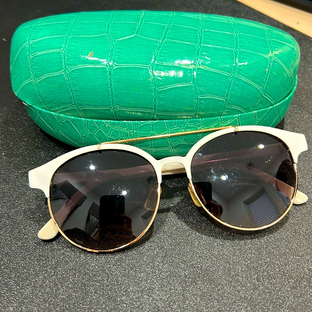 Selling white framed womans sunglasses with an aldo case